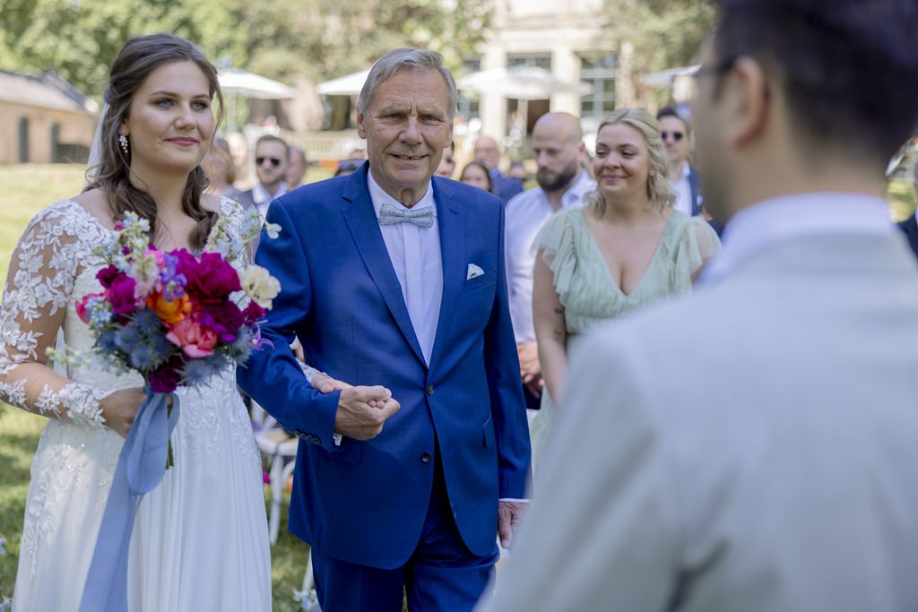 die Braut wird von ihrem Vater auf dem Weg zum Bräutigam begleitet | Hochzeitsfoto: Hanna Witte