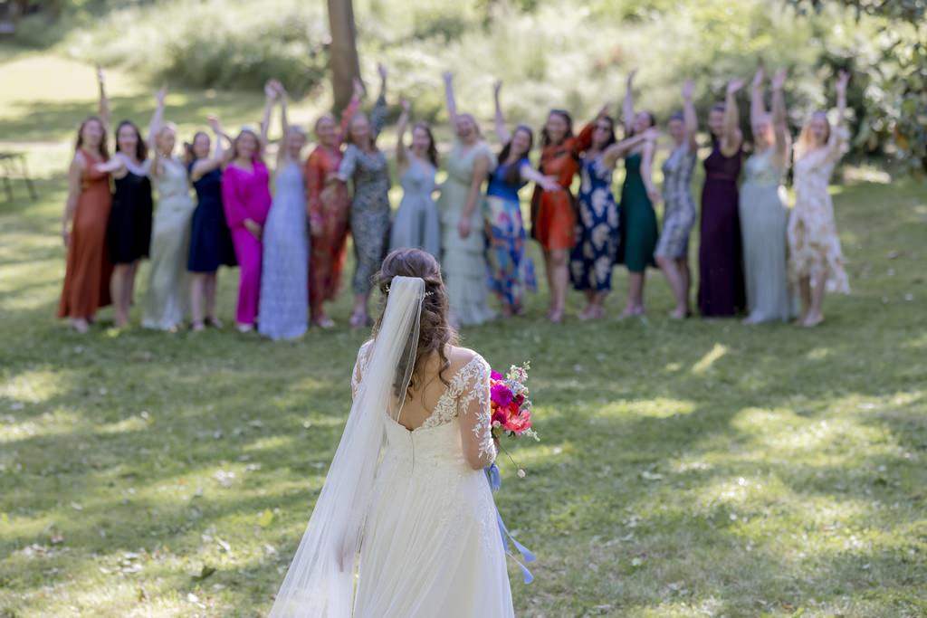 die Braut steht kurz vorm Brautstrauß Wurf vor den weiblichen Hochzeitsgästen | Hochzeitsfoto: Hanna Witte